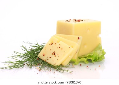 Cut cheese with dill and spices on a white background