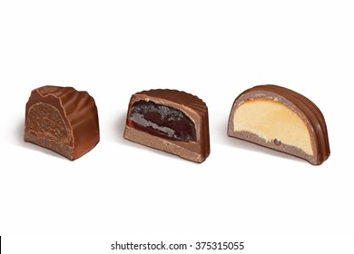 Cut Chocolate Candies With Different Fillings On White Background