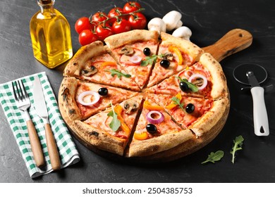 Cut delicious vegetarian pizza, cutlery and ingredients on black table - Powered by Shutterstock