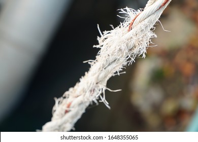 Cut And Frayed Rope Hanging By A Thread And Ready To Break
