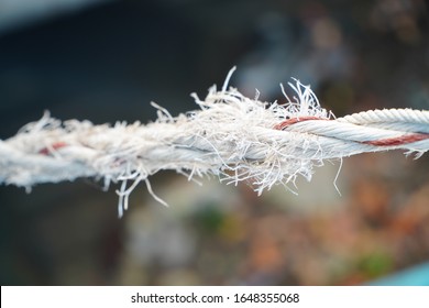 Cut And Frayed Rope Hanging By A Thread And Ready To Break

