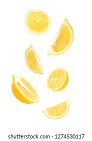 Cut Fresh Lemons Falling Against White Background