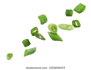 Cut green onion falling on white background
