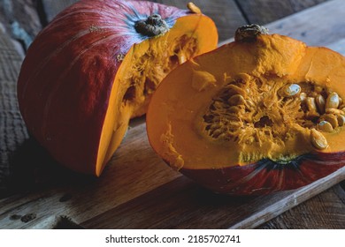 Cut In Half Orange Buttercup Winter Squash On Cutting Board