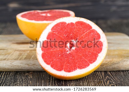 cut into pieces ripe orange red grapefruit, close - up of citrus