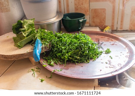 cut kales on a counter in a small kitchen. locally known as sukuma wiki kales is most popular in kenya eaten with ugali