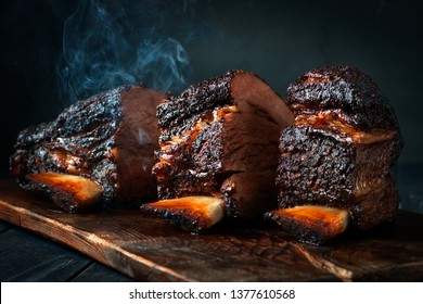 Cut a large piece of smoked beef brisket to the ribs with a dark crust. Classic Texas barbecue - Shutterstock ID 1377610568