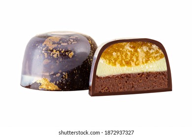 Cut luxury handmade bonbon with chocolate ganache and berry or fruit purees filling isolated on white background. Exclusive handcrafted colorful candies. Product concept for chocolatier