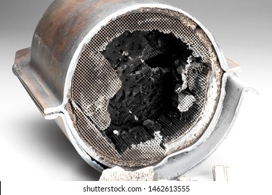 Cut Muffler Car With A Platinum Catalyst. Muffler Of The Exhaust System Of The Car On A White Background.