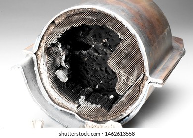 Cut Muffler Car With A Platinum Catalyst. Muffler Of The Exhaust System Of The Car On A White Background.