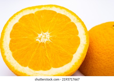 A Cut Navel Orange Placed On A White Background