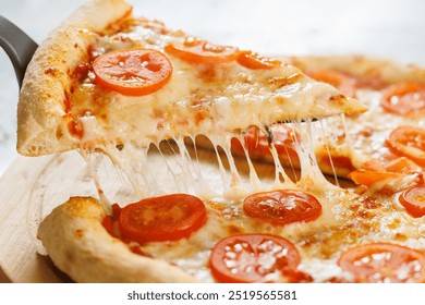 cut off a slice of pizza. melted cheese stretches from the piece - Powered by Shutterstock