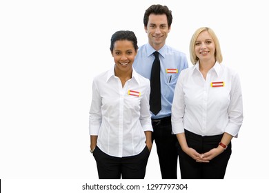 Cut Out Of Smiling Colleagues In Sales Team With Name Badge At Camera