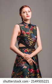 Cut Out Waist Midi Dress In Floral Embroidery With Black High Heels. Ginger Lady Posing In Studio. Evening Colourful Sleeveless Gown With High Neck Line, Female Fashion, Gorgeous Chic Look.