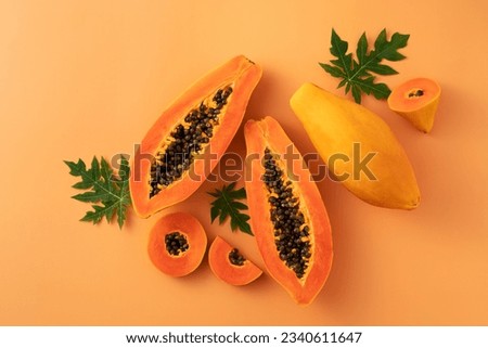 Cut Papaya over orange table background for tropical fruit design concept, top view copy space. Foto d'archivio © 