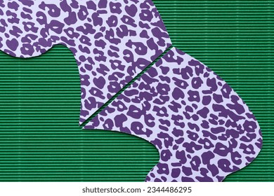 cut paper shape with purple pattern on green corrugated cardboard paper