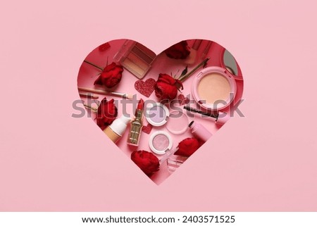 Cut pink paper in shape of heart with cosmetic products and red roses on color background. Valentine's day celebration