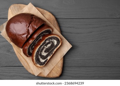 Cut poppy seed roll on grey wooden table, top view with space for text. Tasty cake - Shutterstock ID 2368694239