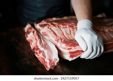 Cut the pork chunks with a knife - Powered by Shutterstock