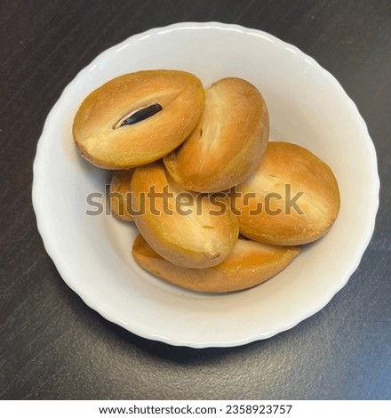 Cut Sapodilla Fruit in a white bowl on a table