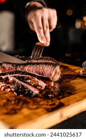 Cut and Served Table Side Tomahawk Steak inside intimate steakhouse restaurant