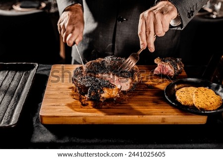 Cut and Served Table Side Tomahawk Steak inside intimate steakhouse restaurant