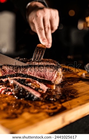 Cut and Served Table Side Tomahawk Steak inside intimate steakhouse restaurant