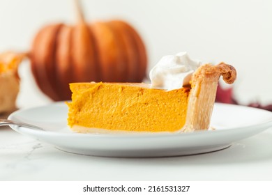 Cut Slice Of Pumpkin Pie Close Up On White Background. Autumn Orange Cake