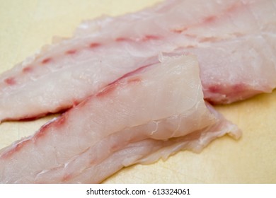 Cut Uncooked Grouper Fillet On Cutting Board