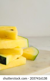 Cut yellow watermelon on table
