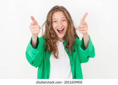 Cut Young Female Girl With Happy Smile, Looking  At Camera, Standing Against White Background In Green Shirt. Portrait Of Fun Teen Student Studio Shot