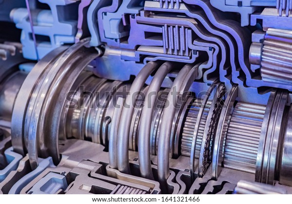 Cutaway engine. Industrial topics. Fragment of\
an internal combustion engine. Chrome tubes inside the car engine.\
Metal mechanism close-up. Concept - Fragment of a metal mechanism.\
Heavy industry