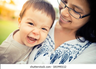 Cute 1 Year Old Asian Boy Playing Outside With His Mother On A Warm Summer Day