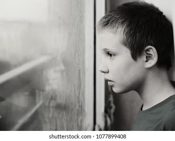 Cute 10 Year Old Autistic Boy Looking At The Rain