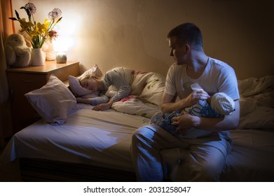 Cute 2 happy married young adult healthy female mum lady worry smile hand hold small new born human male look well health birth heal concept. Little home bedroom pillow mom scene wall view text space - Powered by Shutterstock