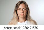 Cute 30s woman look camera. Russian girl face portrait. Ukrainian young adult person. 20 year old lady head shot. Caucasian skin care cream. Blond hair style. No make up life close. White background z