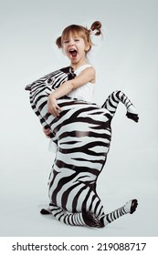 Cute 4 Years Old Kid Girl Posing With Zebra, Studio Shot