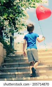 Cute 6 Years Old Boy Holding Red Balloon