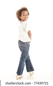 A Cute 7 Year Old African Girl In The Studio Against A White Backdrop.