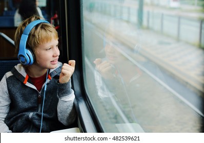 Cute 8 Years Old Boy Looking Through The Window In The Train