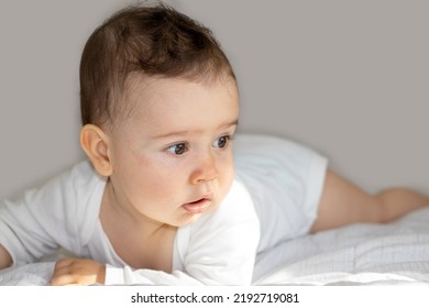 Cute Adorable Baby Boy Lying On Bed Sunny Rays Fall On Pretty Face.toddler On Bed Sit On Tummy Or Back,bedroom Interior Morning Sun.maternity Motherhood,child Growing Up.adorable Innocent Infant Ready