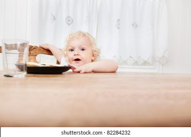 Cute Adorable Baby Reaching For Food On Table