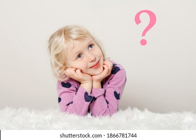 Cute adorable pensive Caucasian girl thinking and dreaming about something. Pink question mark on light simple background. Concept of trouble, problem solving, thinking or missing somebody. - Shutterstock ID 1866781744