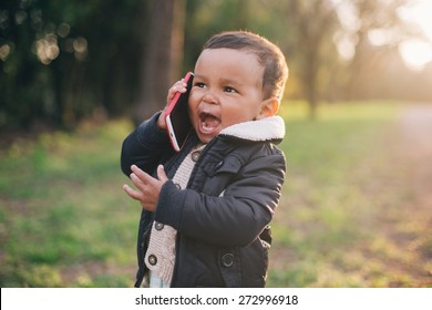 Cute African American Boy playing with Mobile Phone - Powered by Shutterstock