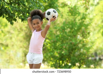 Cute African American Girl With Ball In Park