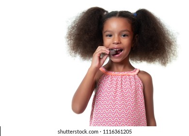 Cute African American Girl Eating A Chocolate Cookie - Isolated On White