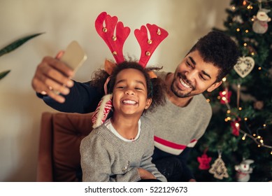 Cute African American Girl Making A Selfie With Dad.