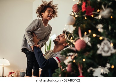 Cute African American Girl Playing With Dad At Home.