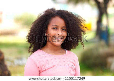 Cute African American girl smiling in the street with afro hair