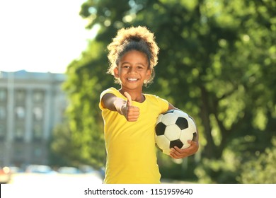 Cute African American girl with soccer ball in park - Powered by Shutterstock